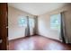 Bedroom with tile floors and curtains, featuring two large windows for natural light at 415 Manor Dr, Bartow, FL 33830