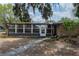 The front exterior of the home shows the sunroom, brick elements, and walkway at 415 Manor Dr, Bartow, FL 33830