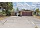 The exterior of this home features a two car garage and an attached single-entry access at 415 Manor Dr, Bartow, FL 33830