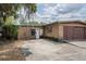This brick home features an attached 2 car garage and a single-entry access point at 415 Manor Dr, Bartow, FL 33830