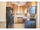 Efficient kitchen featuring wood cabinets and stainless-steel appliances at 415 Manor Dr, Bartow, FL 33830