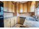 Cozy kitchen with efficient layout, light wood cabinets, and tiled countertops at 415 Manor Dr, Bartow, FL 33830
