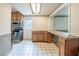 Functional kitchen with wooden cabinetry, white tile floors and modern appliances at 415 Manor Dr, Bartow, FL 33830