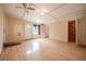 Open and airy living room featuring wood-look floors and multiple entryways at 415 Manor Dr, Bartow, FL 33830