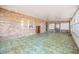 This spacious room features vintage-style flooring and brick accent walls at 415 Manor Dr, Bartow, FL 33830