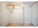 Simple walk-in closet with white concrete walls and a hardwood rod, ready to be customized at 415 Manor Dr, Bartow, FL 33830