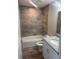 Updated bathroom featuring a tub with tile surround and a granite vanity at 420 S 9Th Ave, Bartow, FL 33830