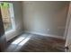 Cozy bedroom features neutral walls, wood-look floors and a large window offering natural light at 420 S 9Th Ave, Bartow, FL 33830