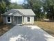 Charming single-story home featuring a freshly poured driveway and verdant landscaping at 420 S 9Th Ave, Bartow, FL 33830