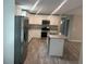 Bright kitchen featuring stainless steel appliances, light cabinets, and a functional center island at 420 S 9Th Ave, Bartow, FL 33830
