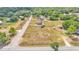 Aerial view showing a mobile home and property with outbuildings and plenty of open space under a sunny sky at 4207 Ollie Rd, Lakeland, FL 33810