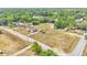 Aerial view of a mobile home on a large lot surrounded by lush greenery, with additional buildings and ample space at 4207 Ollie Rd, Lakeland, FL 33810