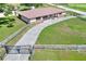 Spacious home with a concrete driveway and metal roof, set on a large lot, surrounded by a wooden fence at 4404 Musket Dr, Lakeland, FL 33810