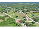 Aerial view of property and neighborhood surrounded by lush greenery and trees at 4404 Musket Dr, Lakeland, FL 33810