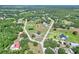 Aerial shot showcasing a home with land, highlighted with an arrow for location, among lush surroundings at 4404 Musket Dr, Lakeland, FL 33810