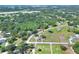 Aerial view of property with lush trees and greenery in rural neighborhood at 4404 Musket Dr, Lakeland, FL 33810