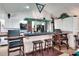 Features a well-lit bar with seating, white cabinetry, and modern appliances at 4404 Musket Dr, Lakeland, FL 33810