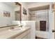 Bathroom showcasing a well-lit vanity with a framed mirror and tiled shower-tub combination at 4404 Musket Dr, Lakeland, FL 33810
