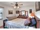 Comfortable bedroom featuring a ceiling fan and dresser with decorative items at 4404 Musket Dr, Lakeland, FL 33810