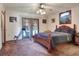 Bedroom showcasing warm carpet, a bed, and doors to the outside at 4404 Musket Dr, Lakeland, FL 33810