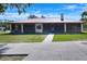 Ranch home featuring a metal roof, screened porches, and well-maintained lawn at 4404 Musket Dr, Lakeland, FL 33810