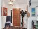 Inviting foyer featuring a hat rack, vintage chair with throw, a detailed light fixture and wood accents at 4404 Musket Dr, Lakeland, FL 33810