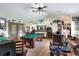 Spacious game room featuring a pool table, wet bar, high ceilings, and comfortable seating at 4404 Musket Dr, Lakeland, FL 33810