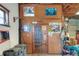 A peek at the garage's wood paneled wall featuring a door, storage shelves, and nostalgic posters at 4404 Musket Dr, Lakeland, FL 33810
