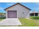 Detached single-car garage, providing secure parking and storage, with a well-maintained lawn at 4404 Musket Dr, Lakeland, FL 33810