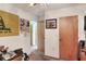 Hallway featuring carpeted floors, doors, and decoratively adorned walls with wall hangings at 4404 Musket Dr, Lakeland, FL 33810