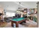 Open concept living room with pool table, fireplace, and large windows at 4404 Musket Dr, Lakeland, FL 33810
