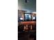 Cozy living room showcasing a stone fireplace, mounted TVs, and Western-themed decor at 4404 Musket Dr, Lakeland, FL 33810