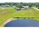Scenic view of a pond with a lush green pasture, adjacent to a well-maintained property and horse at 4404 Musket Dr, Lakeland, FL 33810