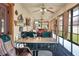 Spacious sunroom with fans, comfortable seating, and a bar area for entertainment at 4404 Musket Dr, Lakeland, FL 33810