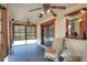 Relaxing sunroom featuring multiple windows, ceiling fans, and chair seating at 4404 Musket Dr, Lakeland, FL 33810