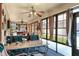 Inviting sunroom with large windows, ceiling fans, and a wet bar, perfect for relaxing at 4404 Musket Dr, Lakeland, FL 33810