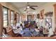 Bright sunroom with ceiling fans, multiple chairs, and large windows at 4404 Musket Dr, Lakeland, FL 33810