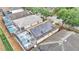High-angle view of a house with solar panels and a screened pool, showcasing community at 506 Henley Cir, Davenport, FL 33896