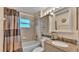 Well-maintained bathroom with updated vanity, granite countertops, and shower at 506 Henley Cir, Davenport, FL 33896