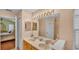 A bathroom with double sinks, a large mirror and a door that leads to a bedroom at 506 Henley Cir, Davenport, FL 33896