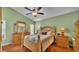 Bedroom boasts wood floors and ample natural light with a ceiling fan at 506 Henley Cir, Davenport, FL 33896