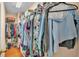 Walk-in closet features an organized space with shelving and hanging rods filled with clothes and shoes at 506 Henley Cir, Davenport, FL 33896