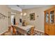 Cozy dining room featuring hardwood floors, a decorative chandelier, and seamless archway transitions at 506 Henley Cir, Davenport, FL 33896