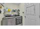 Modern laundry room features front-load washer/dryer and convenient shelving at 506 Henley Cir, Davenport, FL 33896