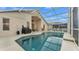 Inviting screened pool area with comfortable lounge chairs, a grill, and serene outdoors at 506 Henley Cir, Davenport, FL 33896