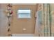 A shower over a tub is tiled and contains several shelves for storage and a curtain at 506 Henley Cir, Davenport, FL 33896