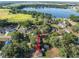 A charming single-story home with a lake view and spacious green yard, surrounded by mature trees at 526 Marklen Loop, Polk City, FL 33868