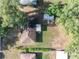 Aerial view of the property showcases the home's layout, yard, and surrounding greenery at 526 Marklen Loop, Polk City, FL 33868