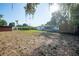 Large backyard featuring a storage shed, lawn, and mature trees offers plenty of room for recreation and relaxation at 526 Marklen Loop, Polk City, FL 33868
