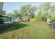 Expansive backyard offers space for outdoor activities and potential landscaping with a storage shed at 526 Marklen Loop, Polk City, FL 33868